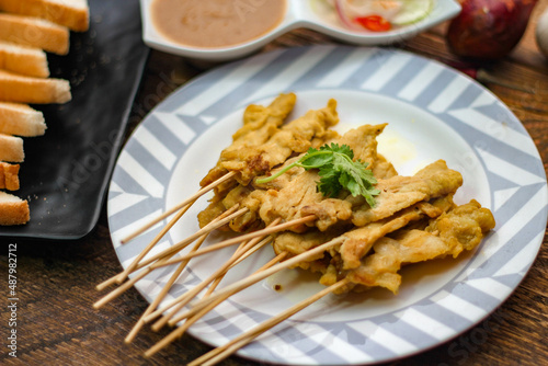 Pork satay - Grilled pork served with peanut sauce or sweet,sour sauce and toast, Thai street food and delicious food in the restaurant.