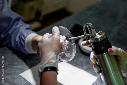 The doctor makes the patient cryotherapy procedure. Close-up of the patient's hand and wounded fingers.