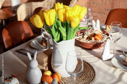 Beautiful tulips on dining table served for Easter celebration