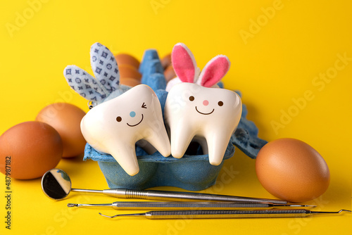 Happy easter.Stomatology concept.eggs, dentist tools and teeth figurines
