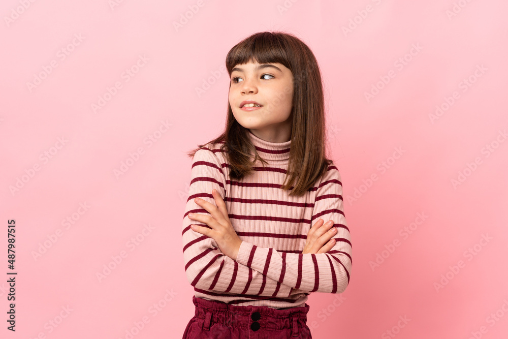 Little girl isolated on pink background looking to the side Little girl isolated on pink background looking to the side