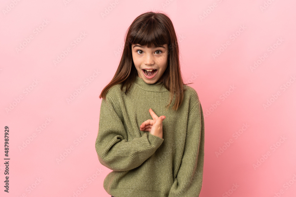 Little girl isolated on pink background with surprise facial expression Little girl isolated on pink background with surprise facial expression