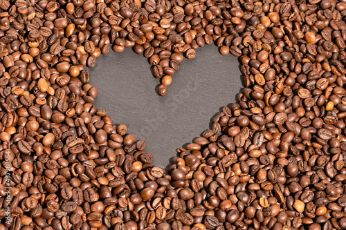 heart shape among coffee beans for background.