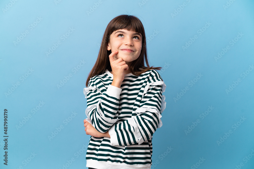 Little girl over isolated background thinking an idea while looking up Little girl over isolated background thinking an idea while looking up