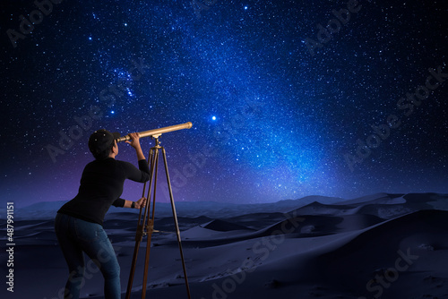 Woman looking at the stars through a telescope фототапет