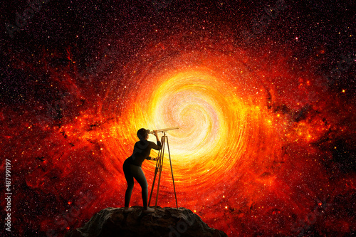 фотография Woman looking at the stars through a telescope