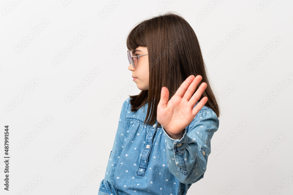 Little girl with sunglasses isolated on white background making stop gesture and disappointed Little girl with sunglasses isolated on white background making stop gesture and disappointed