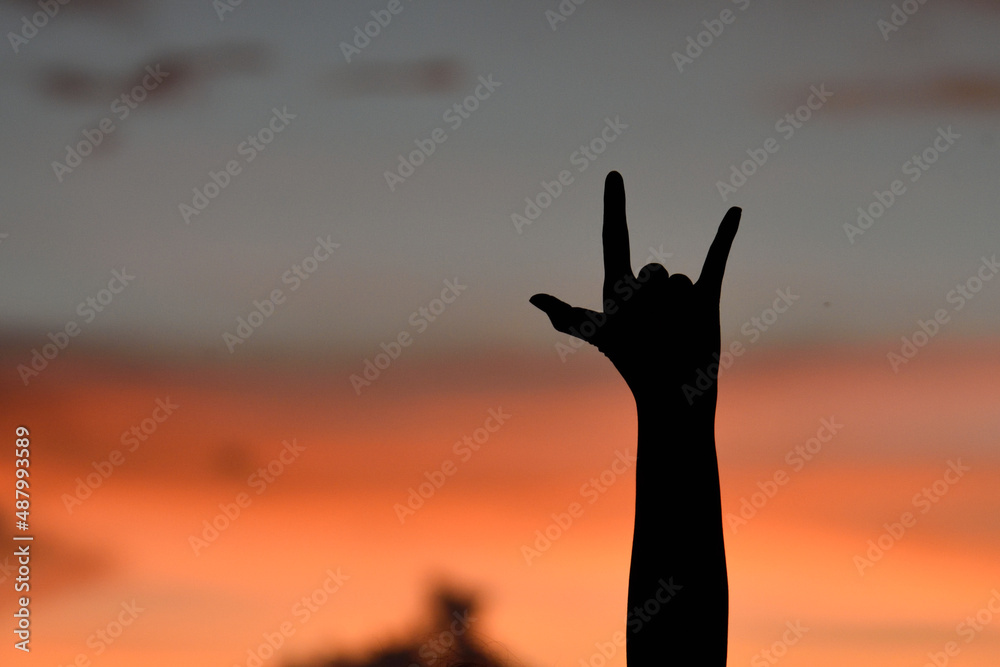 show hand rock music sign or symbol,silhouette twilight time.