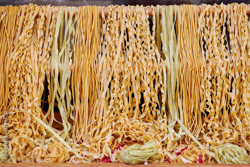Different kinds of pasta and spaghetti at the market place. Dry pasta background.