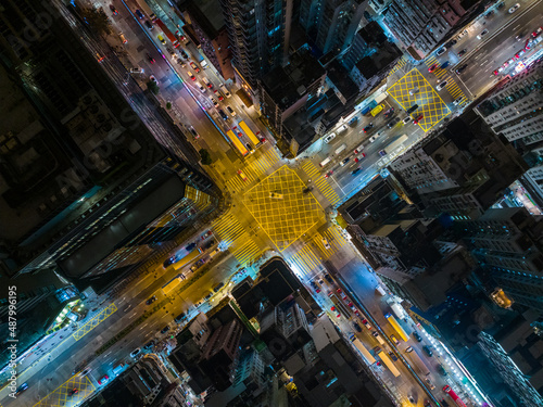 Top down view of Hong Kong city with road intersection at night © leungchopan
