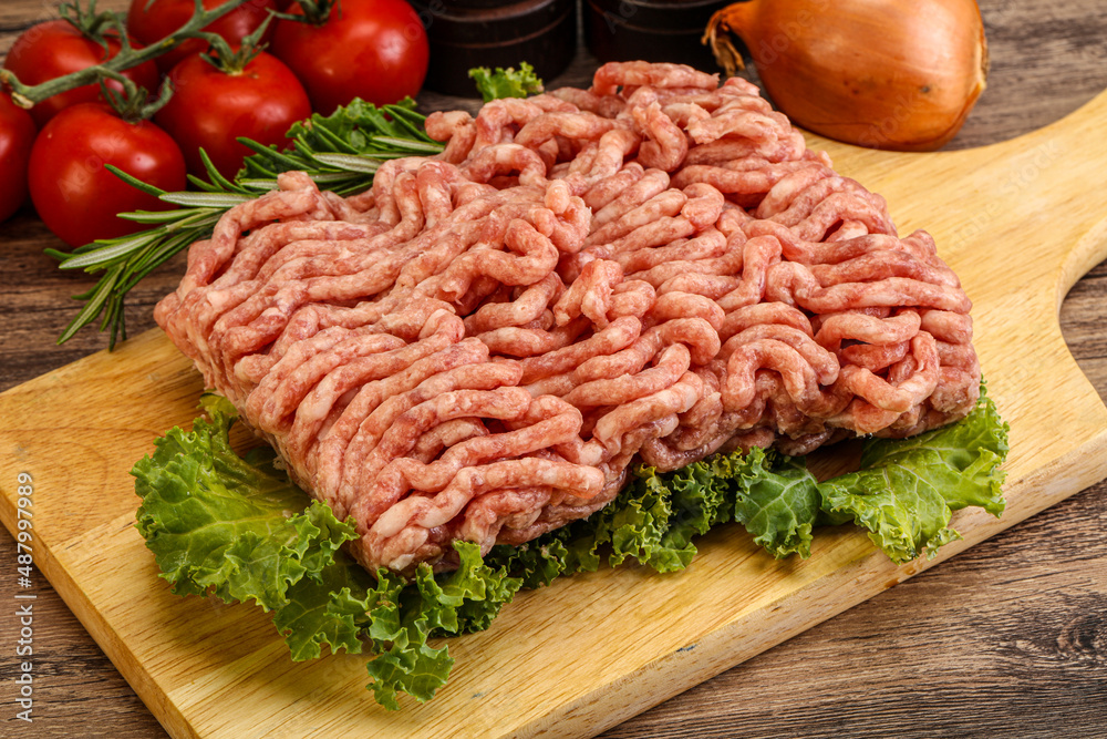 Raw pork minced meat over board Raw pork minced meat over board