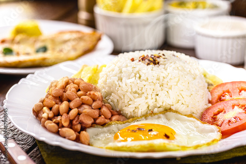 rice and beans typical of brazil, healthy and light food, fried egg and salad, traditional brazilian meal photo
