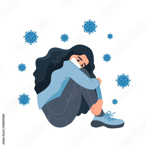 A lonely sad girl is depressed due to isolation during the coronavirus. A girl surrounded by viruses. Stress, depression, crisis. The concept of maintaining mental and physical health