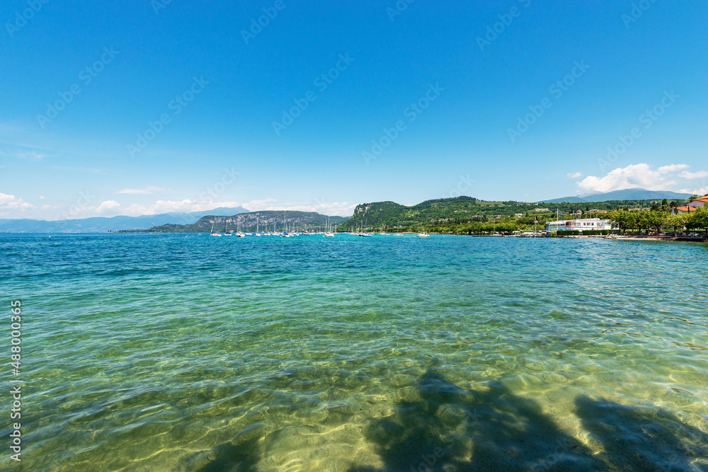 Panorama of Lake Garda (Lago di Garda) from the Small Village of Bardolino with the hills and mountains, tourist resort in Verona province, Veneto, Italy, Europe. On the left the coast of Lombardy.