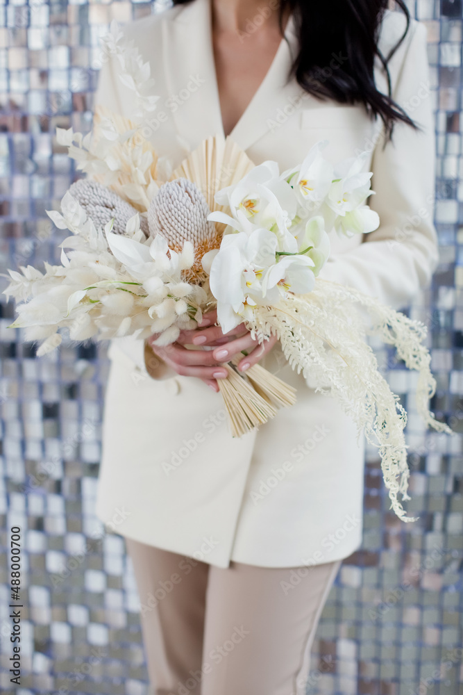 Bride holds wedding boho bouquet