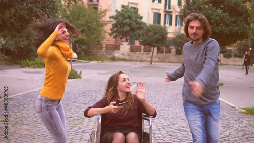 wheelchair user dancing - woman with paraplegia dances with her friends