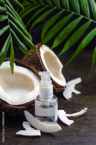 Coconut oil for the face. Cosmetic product in a bottle with a dispenser.