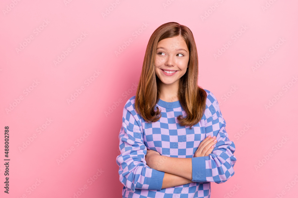 Photo of young cheerful girl crossed hands curious look empty space think idea isolated over pink color background Photo of young cheerful girl crossed hands curious look empty space think idea isolated over pink color background