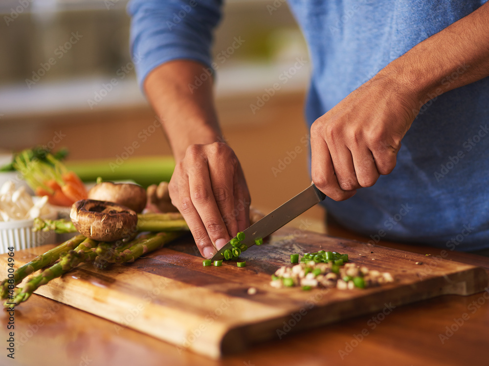 Cooking thats a cut above the rest. Cropped shot of a man preparing a healthy meal at home. Cooking thats a cut above the rest. Cropped shot of a man preparing a healthy meal at home.