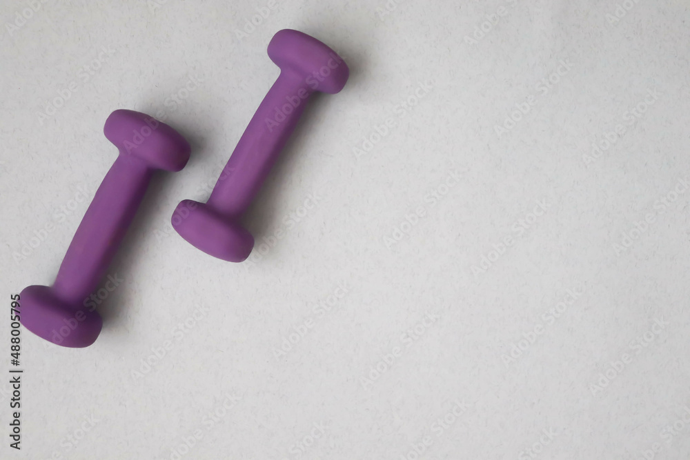 Dumbbells on a light background Dumbbells on a light background