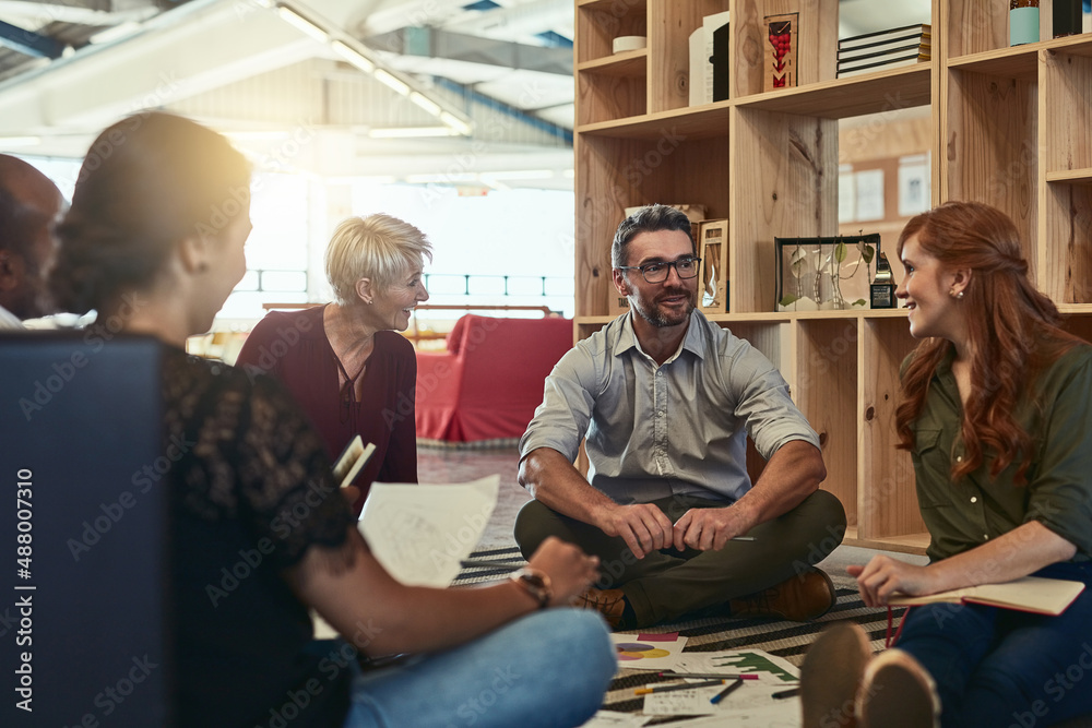 I like this business environment we have. Cropped shot of a group of business colleagues in the office sitting on the floor and discussing ideas. I like this business environment we have. Cropped shot of a group of business colleagues in the office sitting on the floor and discussing ideas.