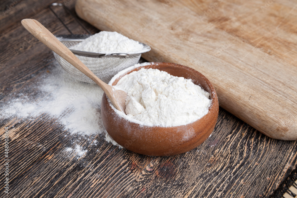wheat flour in a wooden bowl wheat flour in a wooden bowl