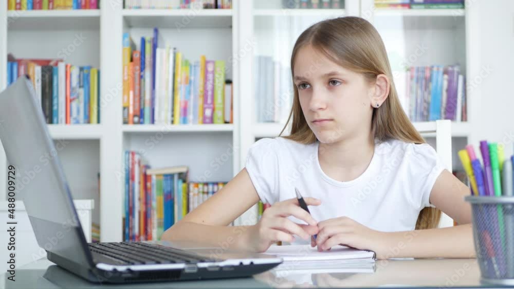 Bored Child Studying on Laptop for School, Sad Kid Working on PC in Office, Student Girl Writing Homework, Online Education Bored Child Studying on Laptop for School, Sad Kid Working on PC in Office, Student Girl Writing Homework, Online Education