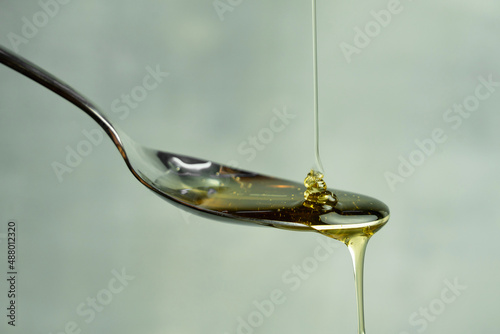 Pouring honey, honey dripping from a spoon