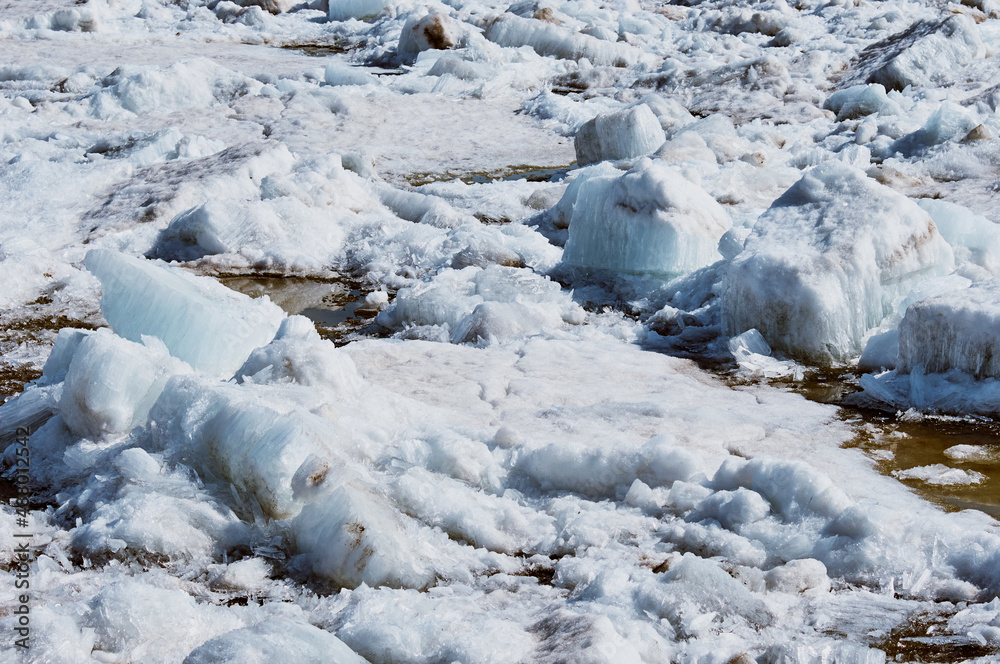 Ice drift on the Amur River. Melting ice floes in spring. A heap of blocks and fragments. Sunny day. Ice drift on the Amur River. Melting ice floes in spring. A heap of blocks and fragments. Sunny day.