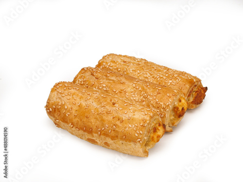 Puff on a white background. Rollini with cheese and spinach