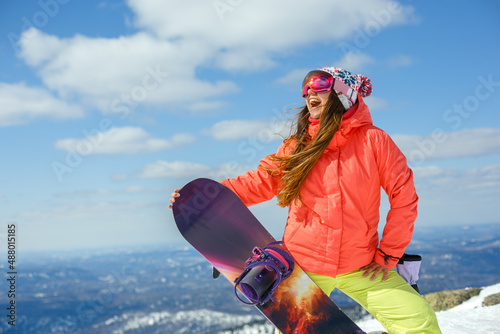 Girl snowboarder enjoys the ski resort