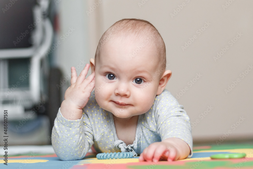 Portrait of a little girl one year old who looks at the camera and smiles sweetly. Child, girl, holiday. Portrait of a little girl one year old who looks at the camera and smiles sweetly. Child, girl, holiday.