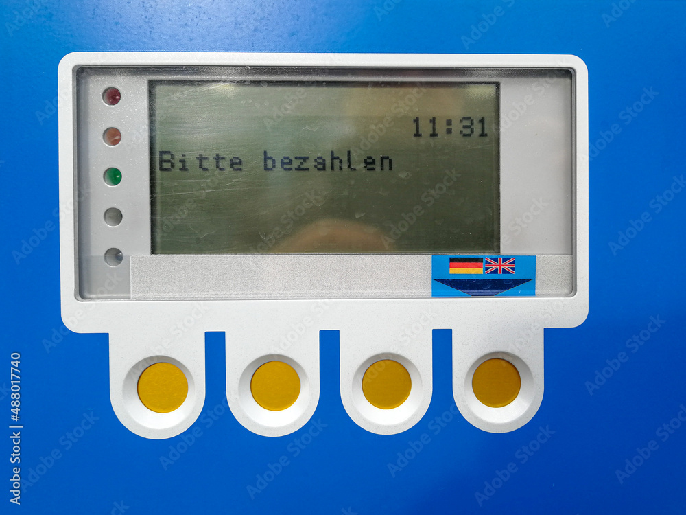 LCD control panel and function keys of a blue parking meter with the prompt Payment required in german language LCD control panel and function keys of a blue parking meter with the prompt Payment required in german language
