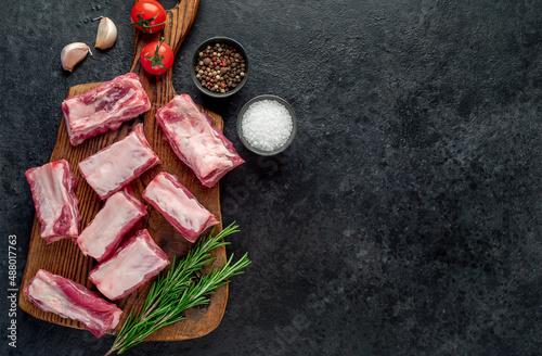 sliced ​​pork ribs on a stone background with copy space for your text