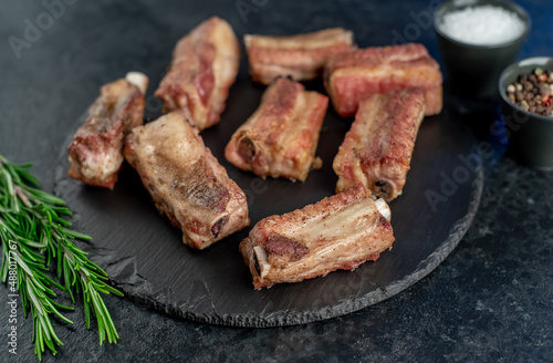 grilled sliced ​​pork ribs on stone background
