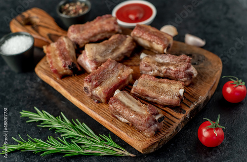 grilled sliced ​​pork ribs on stone background