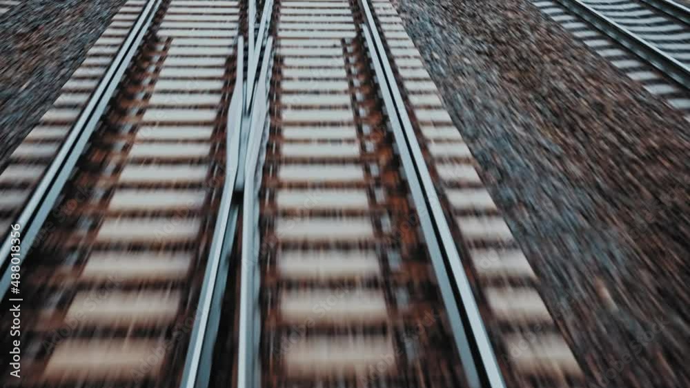 Fast Moving Railway Track with Switches Concrete Railroad Ties and Crushed Stone Track Ballast Seen from Train Driver Seat