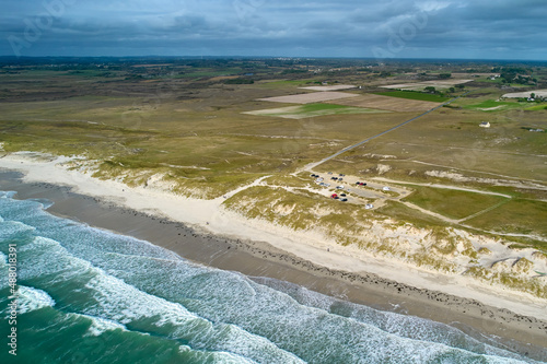 Aerial view of french beach in the brittany. Parking for campers behind the dune. Sea with waves. Vacation in Tronoan, near La torche in France. photo