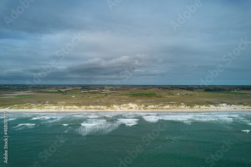 Aerial view of french beach in the brittany. Sea with waves in rural area. Vacation in Tronoan, near La torche in France. photo