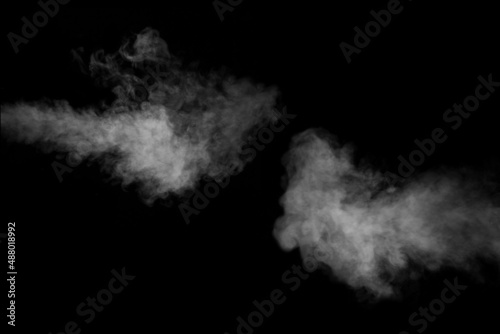 A set of two rich, swirling horizontal vapors isolated on a black background for overlaying on your photos. Fragment of horizontal steam. Abstract smoky background, design element
