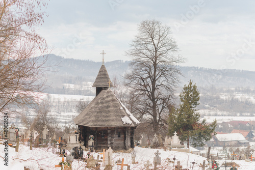 Located in a beautiful and quiet village Sinca Noua, Transylvania, Brasov, the Old Wooden Church is an impressive building with a long history that still preserves its medieval structure photo