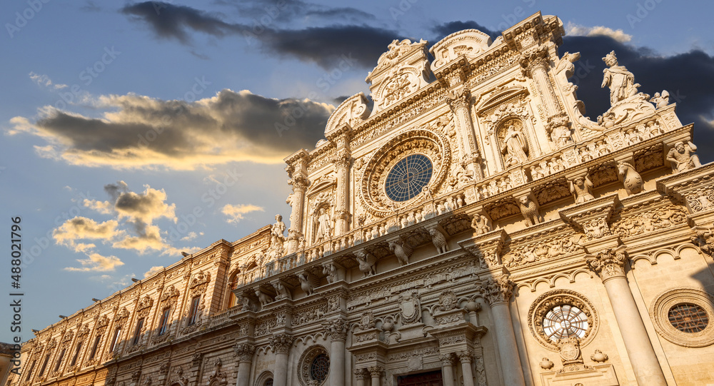 Lecce, Puglia, Italy. August 2021. The church of Santa Croce is the finest example of Lecce baroque. The view displays it in all its beauty with late afternoon light. People.