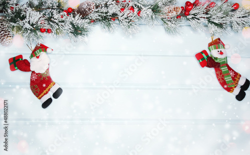 christmas santa toy with fir branches decor and snow © Anastasia Tsarskaya