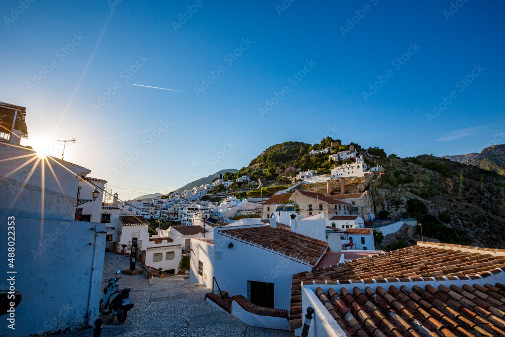 Frigiliana, Malaga, Spain. Sunny spring day street travel view. Sun light diffraction star effect