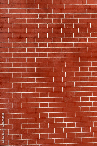 Brick wall is bright red, texture of stone blocks, background of bricks.