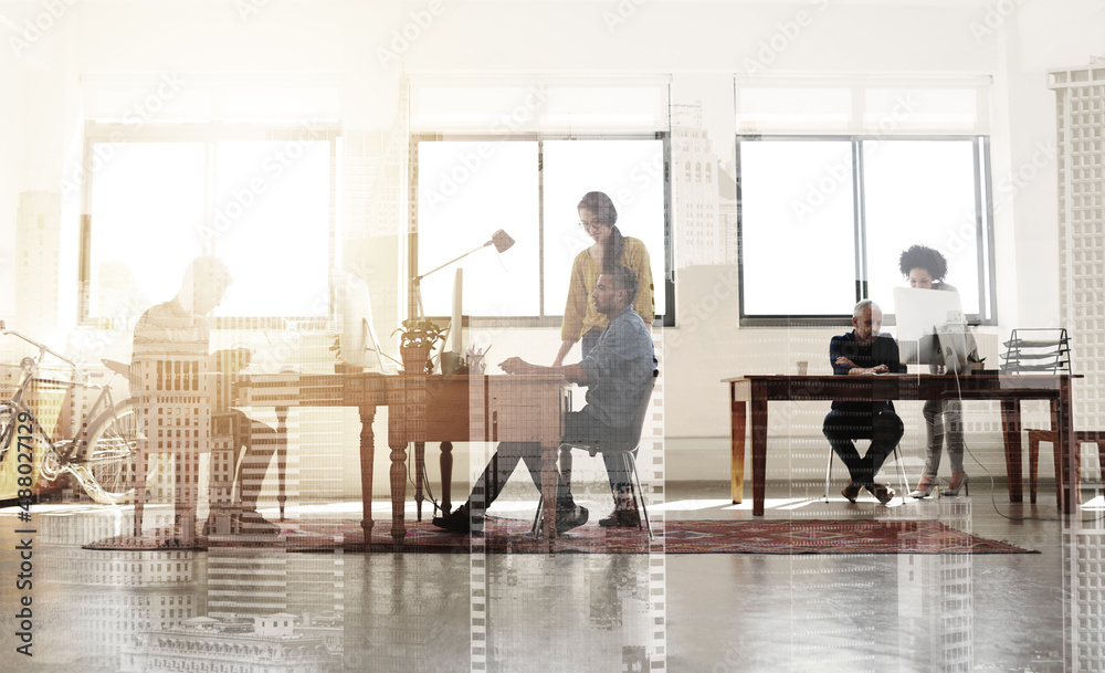 Designers doing what they do best. Multiple exposure shot of colleagues working in a modern office superimposed over a city background. Designers doing what they do best. Multiple exposure shot of colleagues working in a modern office superimposed over a city background.