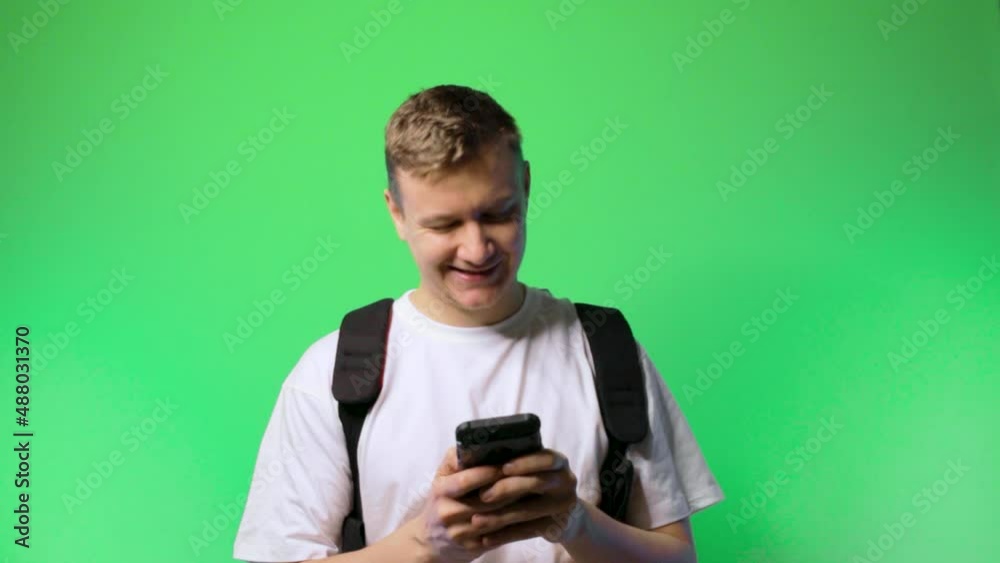 young man student communicates via texting flirting dating chroma key background.concept dating app young man student communicates via texting flirting dating chroma key background.concept dating app