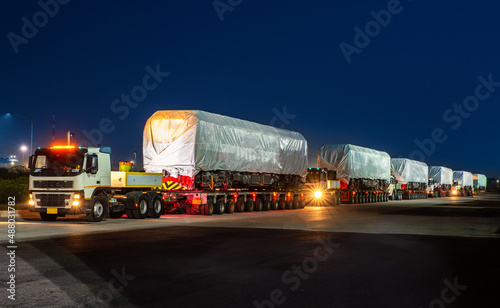 heavy oversize cargo truck Loading a new locomotive port area
