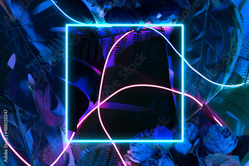 Fototapeta Naklejka Na Ścianę i Meble -  Neon square frame on a dark floral jungle background. Artificial reality conceptual template.