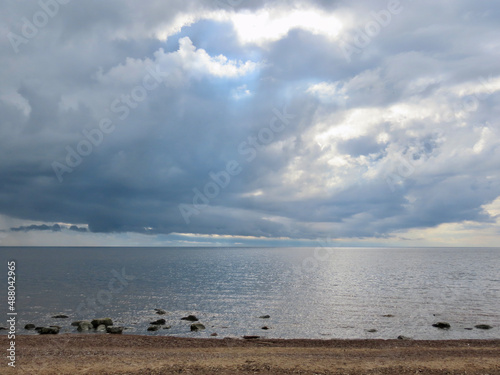 Heavy weather front over Baltic sea, calm blue sea, dark clouds